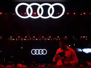 A man walks past a logo of German automobile manufacturer Audi ahead of the launch of the Audi Q8 e-tron and the Audi Q8 Sportback e-tron electric SUVs in Mumbai
