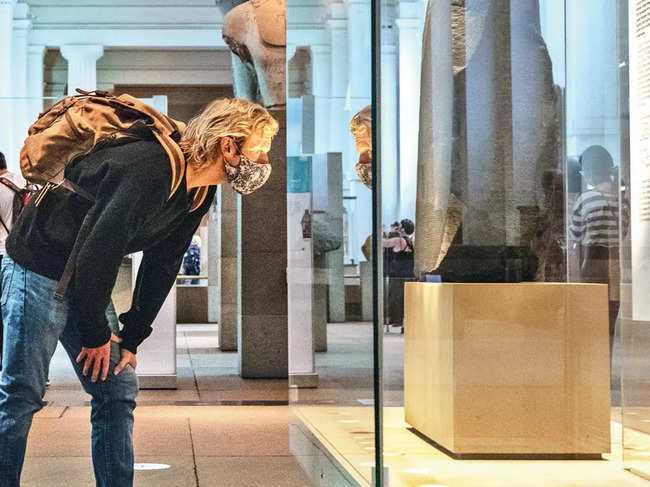 A visitor observes the Rosetta Stone