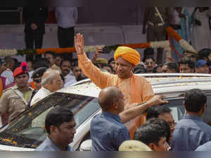 Lucknow: Uttar Pradesh Chief Minister Yogi Adityanath waves as he arrives for th...