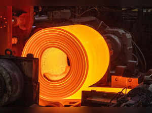 A roll of coiled steel leaves the coil box on the steel production line at the Tata Steel Port Talbot integrated iron and steel works in south Wales on 15 August, 2023. Port Talbot's integrated steelworks is responsible for producing high quality steel, as well as shaping the town’s iconic skyline. It performs several identifiable processes which occur throughout the site so that raw iron ores and coal can be converted into ‘slab’ and finished steel products.   (Photo by Geoff Caddick / AFP)