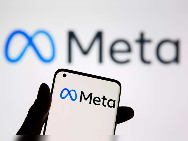 FILE PHOTO: A smartphone with Meta logo is seen in front of displayed Facebook's new rebrand logo Meta in this illustration