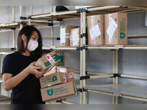 An employee packs goods at Goto's e-commerce unit Tokopedia's warehouse in Jakarta