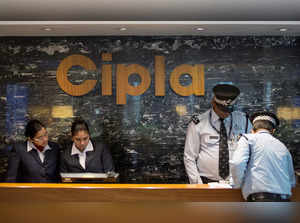 Employees and security staff work at the reception area of Cipla at its headquarters in Mumbai
