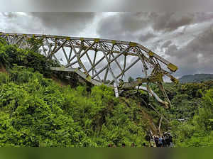 Aizawl: Locals at the site after an under-construction railway bridge at Sairang...