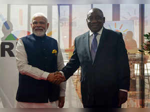 Indian Prime Minister Narendra Modi shakes hands with South African President Cyril Ramaphosa at the BRICS Summit in Johannesburg on August 23, 2023. (Photo by ALET PRETORIUS / POOL / AFP)