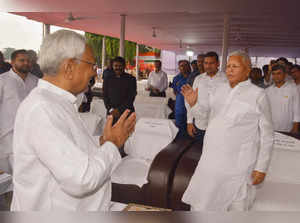 Patna: Bihar Chief Minister Nitish Kumar exchanges greetings with RJD chief Lalu...