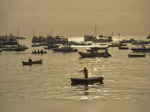 Mumbai: A fisherman rows his boat near Gateway of India during early morning hou...