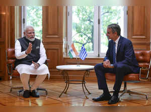 India's Prime Minister Narendra Modi, left, talks with his Greek counterpart Kyr...