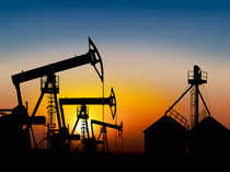Oil prices up 1% on supply cuts, despite strong dollar, weak economic news