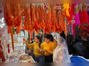 Shimla: Young women buy ‘Rakhi’ ahead of 'Raksha Bandhan' festival, in Shimla. (...