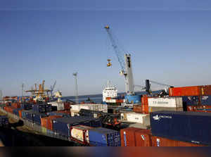 FILE PHOTO: Workers unload containers at the Port of Lisbon