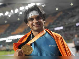 Neeraj Chopra, of India, poses after winning the gold medal in the Men's javelin...