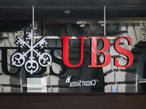 A sign of Swiss giant banking UBS is seen above a sign of Credit Suisse in Zurich on August 30, 2023 on the eve of the of the announcement of its first results since Credit Suisse merger.
