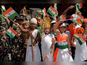 School children dressed as freedom fighters and deities wave Indian national flags ahead of the country's Independence day in Amritsar on August 12, 2023.  (Photo by Narinder NANU / AFP)