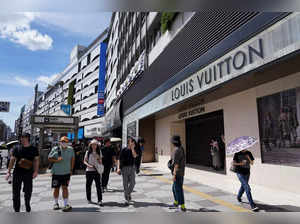 People walk in front of a Louis Vuitton store located in the Seibu Ikebukuro main store, which is temporarily closed during the strike in Tokyo on August 31, 2023.