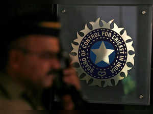 FILE PHOTO: A policeman walks past logo of BCCI in Mumbai