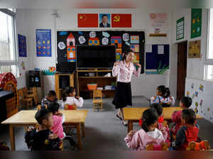 FILE PHOTO: Teacher gives a class to children at a preschool in Xujiashan village, in Haitang