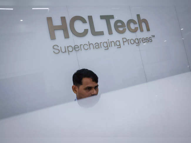 An employee sits at the front desk inside HCL Technologies headquarters in Noida