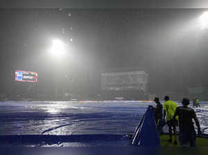 Sri Lankan ground staff pull covers as it rains during the Asia Cup cricket matc...