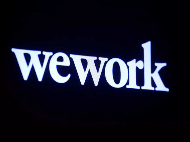 FILE PHOTO: The WeWork logo is displayed on a screen during the company's IPO on the floor of the NYSE in New York