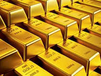 Gold hovers near 1-week low as dollar firms after US data