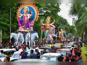 Mumbai: Devotees carry idols of Lord Ganesha to a pandal ahead of the Ganesh Cha...