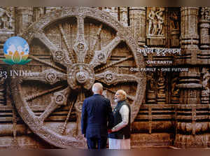 India's Prime Minister Narendra Modi (R) shows a mural of Konark Sun temple wheel from Indian state of Orissa to US President Joe Biden ahead of the G20 Leaders' Summit in New Delhi on September 9, 2023.