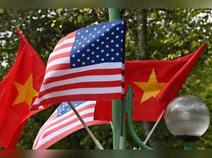 US and Vietnam national flags fly on a street light in Hanoi on September 10, 2023, ahead of US President Joe Biden's visit to Vietnam.