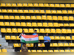 Indian fans hold national flag as they stand for national anthem before the start of the Asia Cup 2023 super four one-day international (ODI) cricket match between India and Pakistan at the R. Premadasa Stadium in Colombo on September 10, 2023.
