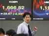 Asian markets end lower after Spain downgrade