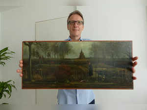An handout picture released by Dutch art detective Arthur Brand shows a portrait of him posing with the painting title "Parsonage Garden at Nuenen in Spring", painted by Vincent van Gogh in 1884, at his home in Amsterdam on September 11, 2023.