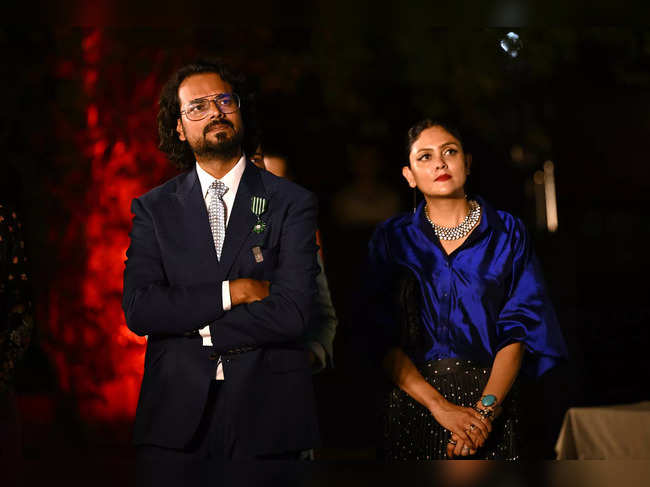Indian fashion designer Rahul Mishra (L) with wife Divya Bhatt Mishra look on after the latter was awarded the 'Chevalier de l'ordre des Arts et des Lettres' or the 'Knight of the Order of Arts and Letters' title award during an ceremony in New Delhi on September 12, 2023.
