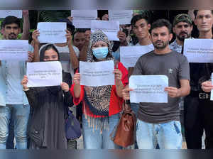 Afghan students living in India hold placards during a protest demanding extension of their study visa and scholarships, in New Delhi