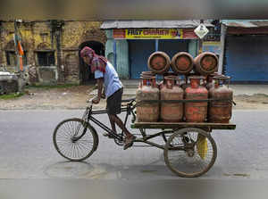 nadia: A worker carries LPG cylinders in a cart, in Nadia district. The governme...