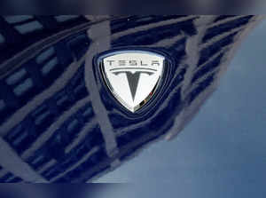 FILE PHOTO: A logo of Tesla Motors on an electric car model is seen outside a showroom in New York