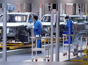 FILE PHOTO: Employees work on assembly line during a construction completion event of SAIC Volkswagen MEB electric vehicle plant in Shanghai
