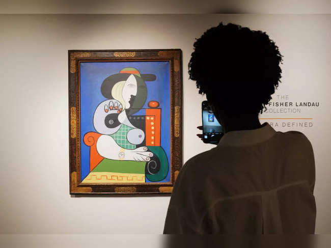 A visitor looks over Pablo Picasso’s painting Femme á la montre, the painting will be auctioned in November as part of the Emily Fisher Landau Collection and is expected to fetch $120 million, pictured on display at Sotheby’s on September 13, 2023 in New York.