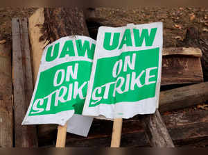 FILE PHOTO: "UAW on strike" picket signs lay on a pile of wood outside the General Motors Detroit-Hamtramck Assembly in Hamtramck
