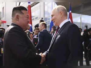 Russian President Vladimir Putin, right, and North Korea's leader Kim Jong Un sh...