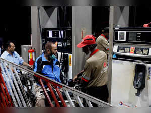 People get fuel at a petrol station after the government announced the increase of petrol and diesel prices