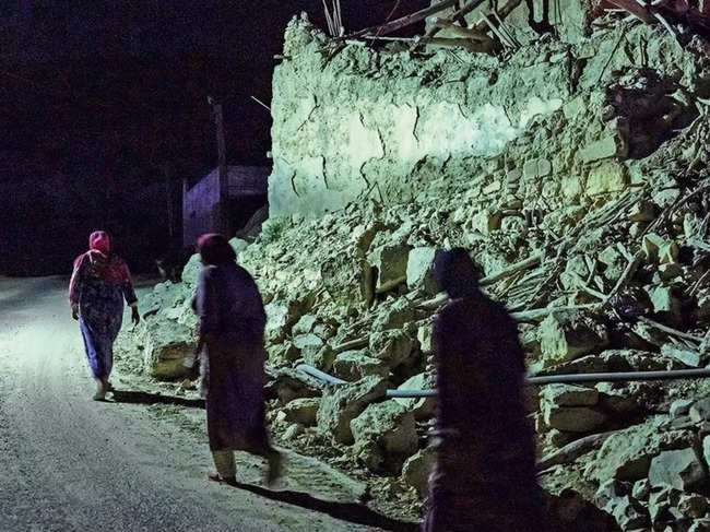 People walk by the rubble in earthquake-hit Taroudant, Morocco