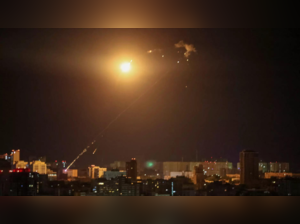 An explosion of a drone is seen in the sky over the city during a Russian drone strike, amid Russia's attack on Ukraine