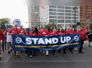 FILE PHOTO: United Auto Workers members march in the street in support of striking auto workers