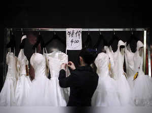 FILE PHOTO:  Vendor prepares wedding dresses at a show room during the China International Wedding Expo in Shanghai