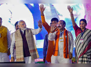 Raigarh: Prime Minister Narendra Modi with Chhattisgarh State President Arun Sao...