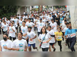 Dehradun: People take part in 'Swachhata League Marathon', in Dehradun. (PTI Pho...