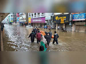 **EDS: TO GO WITH STORY** Nagpur: Rescue team officials wade through a waterlogg...