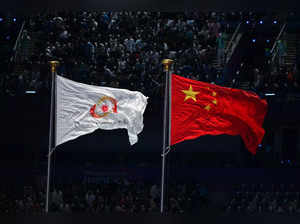 The Olympic Council of Asia flag (L) and China's national flag are displayed during the opening ceremony of the 2022 Asian Games at the Hangzhou Olympic Sports Centre Stadium in Hangzhou in China's eastern Zhejiang province on September 23, 2023.