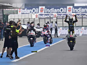 Mooney VR46 Racing Team's Italian rider Marco Bezzecchi (R) celebrates after winning the Indian MotoGP Grand Prix at the Buddh International Circuit in Greater Noida on the outskirts of New Delhi, on September 24, 2023.