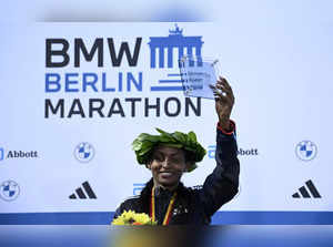 Ethiopia's Tigist Assefa celebrates on the podium with her trophy after winning the women's race of the Berlin Marathon on September 24, 2023 in Berlin, Germany.